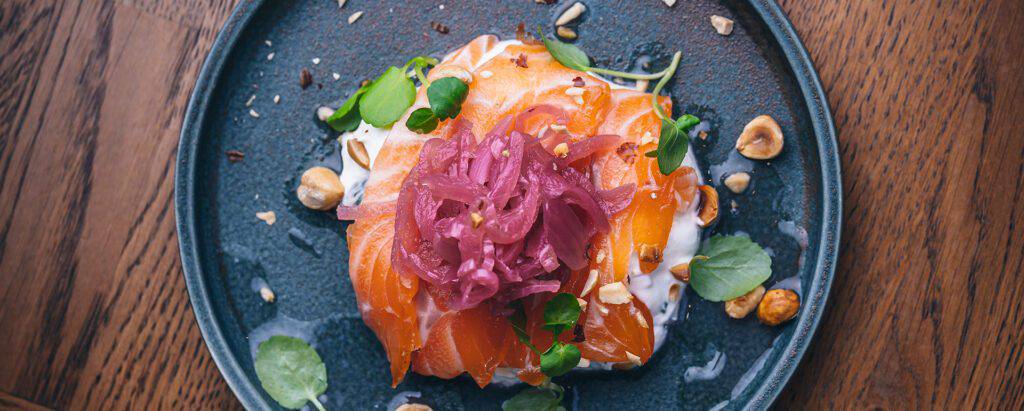 A plate of smoked salmon and red onion relish